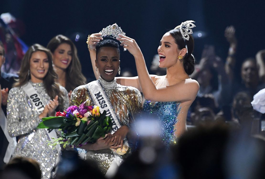 Miss Universe 2019, Zozibini Tunzi, receives the crown from 2018 winner Catriona Gray.