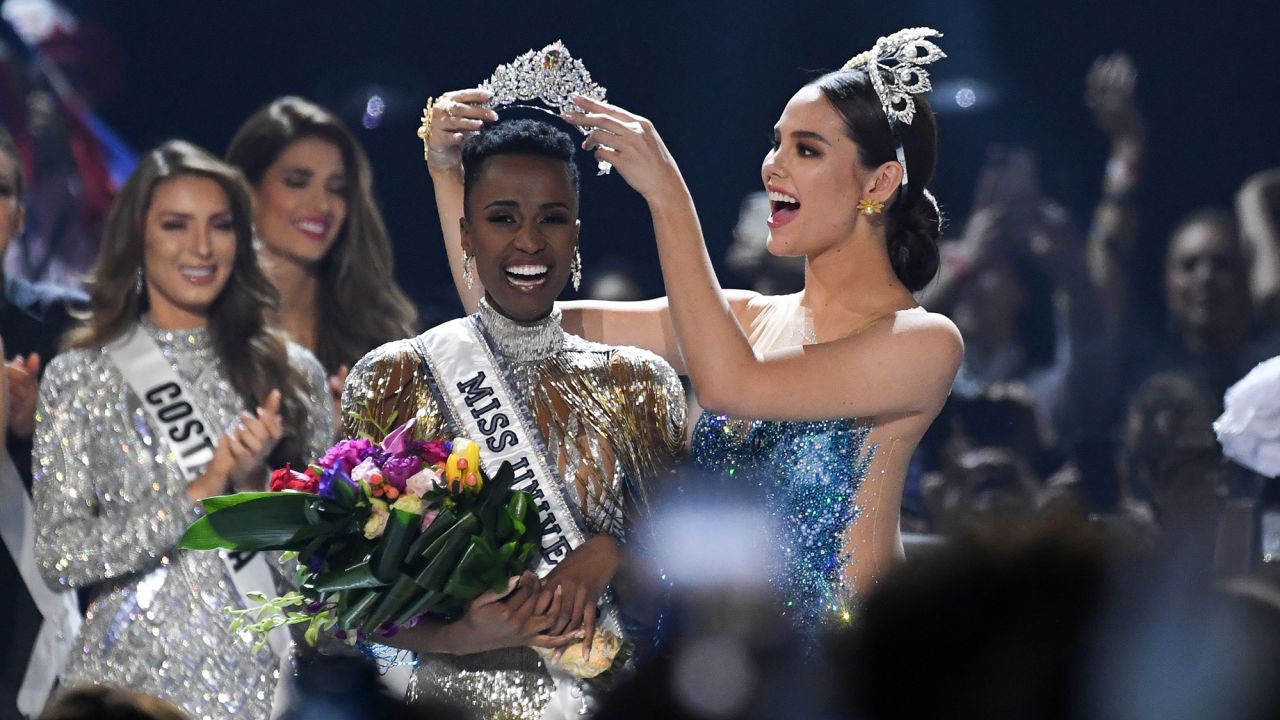 Miss Universe 2018 Philippines' Catriona Gray (R) crowns the new Miss Universe 2019 South Africa's Zozibini Tunzi on stage during the 2019 Miss Universe pageant at the Tyler Perry Studios in Atlanta, Georgia on December 8, 2019. (Photo by VALERIE MACON / AFP) (Photo by VALERIE MACON/AFP via Getty Images)