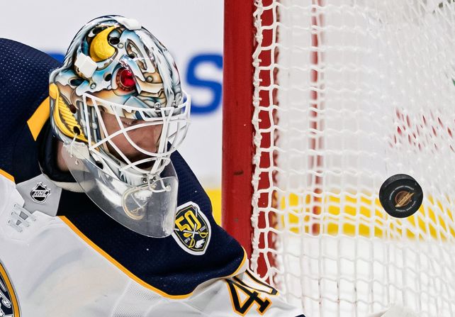 Buffalo Sabres goalie Carter Hutton watches the puck bounce off the side of the net during an NHL hockey game against the Vancouver Canucks on Saturday, December 7, in Vancouver, British Columbia. 