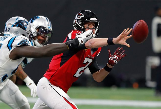 Atlanta Falcons quarterback Matt Ryan attempts a shuttle pass with pressure from the Carolina Panthers at Mercedes-Benz Stadium on Sunday, December 8, in Atlanta, Georgia. 