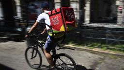 VIA SACCHI, TURIN, ITALY - 2019/08/02: A Just Eat courier rides during his work. Just Eat is a online food delivery app (as Glovo, Uber Eats and Foodora) that hires food riders as independent contractors. (Photo by Nicolò Campo/LightRocket via Getty Images)
