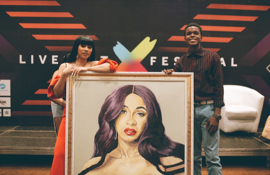 Award-winning rapper, Cardi B, receives painting from Nigerian artist during her visit to the West African country. Photo by Faje Kashope