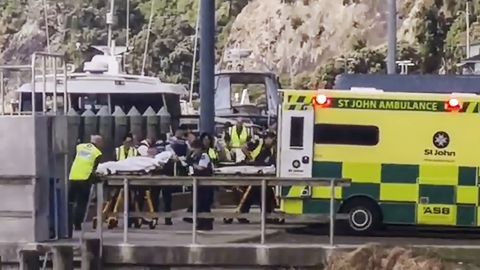 Injured from White Island volcanic eruption are ferried into waiting ambulances in Whakatane, New Zealand, Monday.
