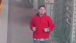 An image taken from video provided by the PHoenix Police Department shows a suspect running away after he tried to steal a woman's wheelchair on a light rail car.