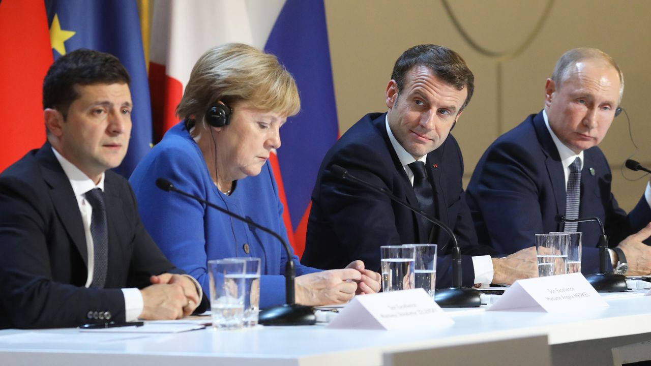 (FromL) Ukrainian President Volodymyr Zelensky, German Chancellor Angela Merkel, French President Emmanuel Macron and Russian President Vladimir Putin give a press conference after a summit on Ukraine at the Elysee Palace, in Paris, on December 9, 2019. - Leaders aim for new withdrawal of forces from Ukraine conflict zones by March 2020, according to a communique on December 9, 2019. (Photo by LUDOVIC MARIN / POOL / AFP) (Photo by LUDOVIC MARIN/POOL/AFP via Getty Images)