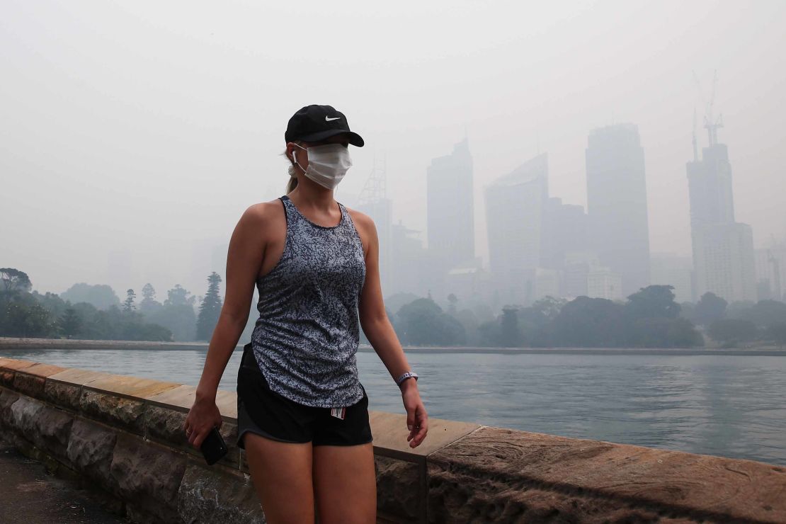 Bushfire smoke smothered Sydney on Tuesday, setting off fire alarms, suspending ferry services and triggering health warnings over choking air pollution.