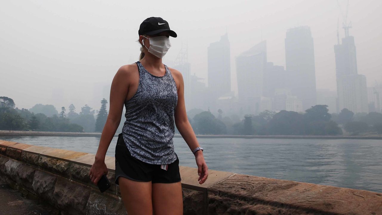 Bushfire smoke smothered Sydney on Tuesday, setting off fire alarms, suspending ferry services and triggering health warnings over choking air pollution.