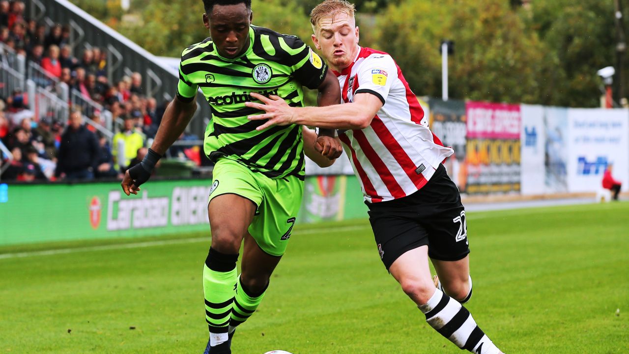 Forest Green's Udoka Godwin-Malife (left) challenges for the ball against Exeter City's Jack Sparkes during a League Two match.