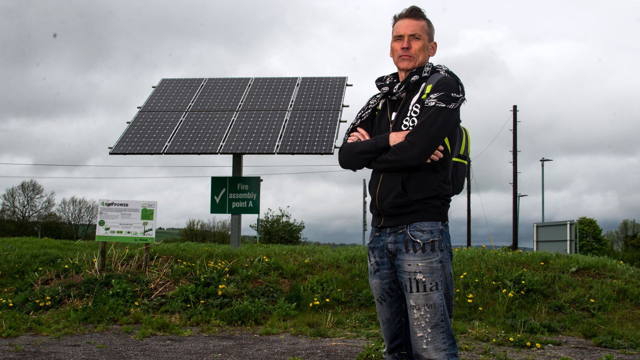 Dale Vince, chairman of Forest Green Rovers, poses next to a solar panel at the New Lawn. The Stadium is completely fulled by renewable energy.