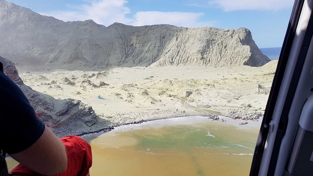 This December 2019 photo provided by Auckland Rescue Helicopter Trust shows ash-covered White Island, New Zealand, following the eruption of the volcano.