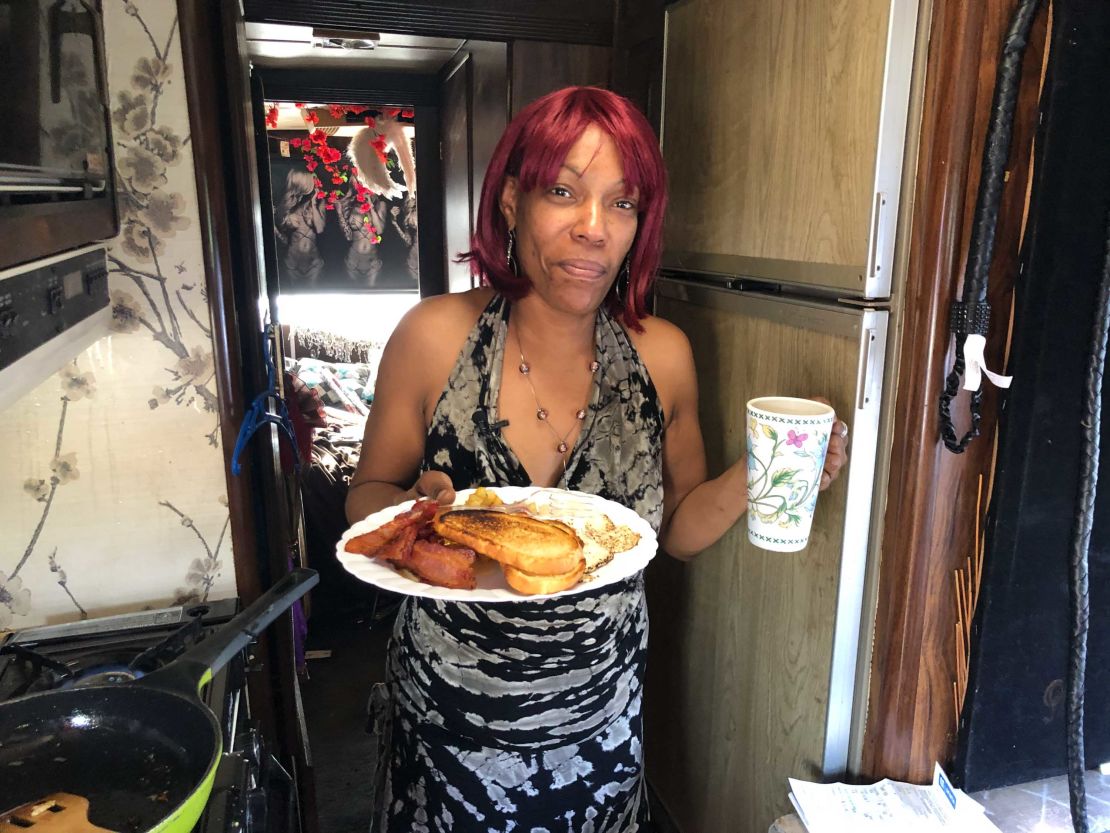 Sharhonda Beavers enjoys a meal in RV, which she opened to a friend she met on the streets.