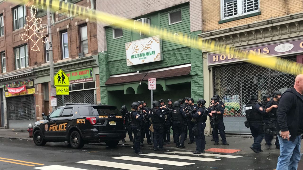 A police officer, three civilians and the two suspects were killed in the shooting, authorities said.