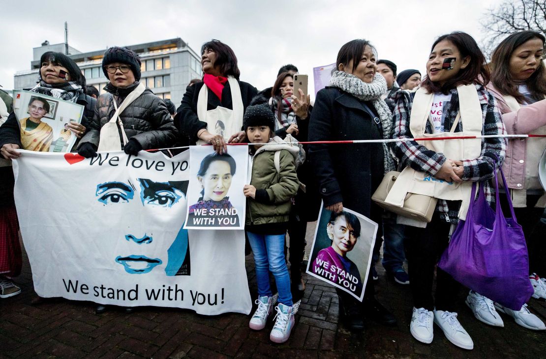 Protesters in support of Myanmar's State Counsellor Aung San Suu Kyi stand in front of the Peace Palace of The Hague.