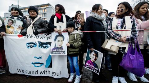 Protesters in support of Myanmar's State Counsellor Aung San Suu Kyi stand in front of the Peace Palace of The Hague.