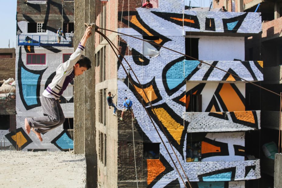 Working with "El Seed" is not for the fainthearted, as shown by artists collaborating on his "Perception" mural in Cairo.  