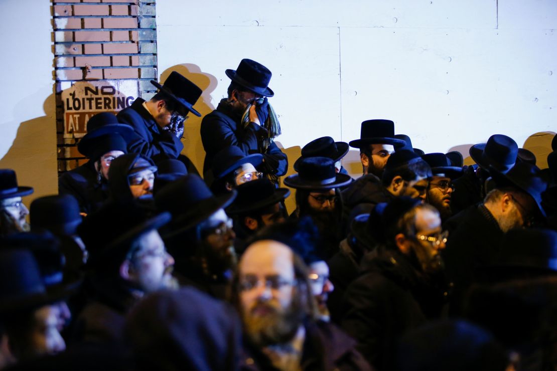 Orthodox Jewish men mourn during the funeral service of Mindy Ferencz who was killed in a kosher market that was the site of a gun battle in Jersey City, New Jersey.