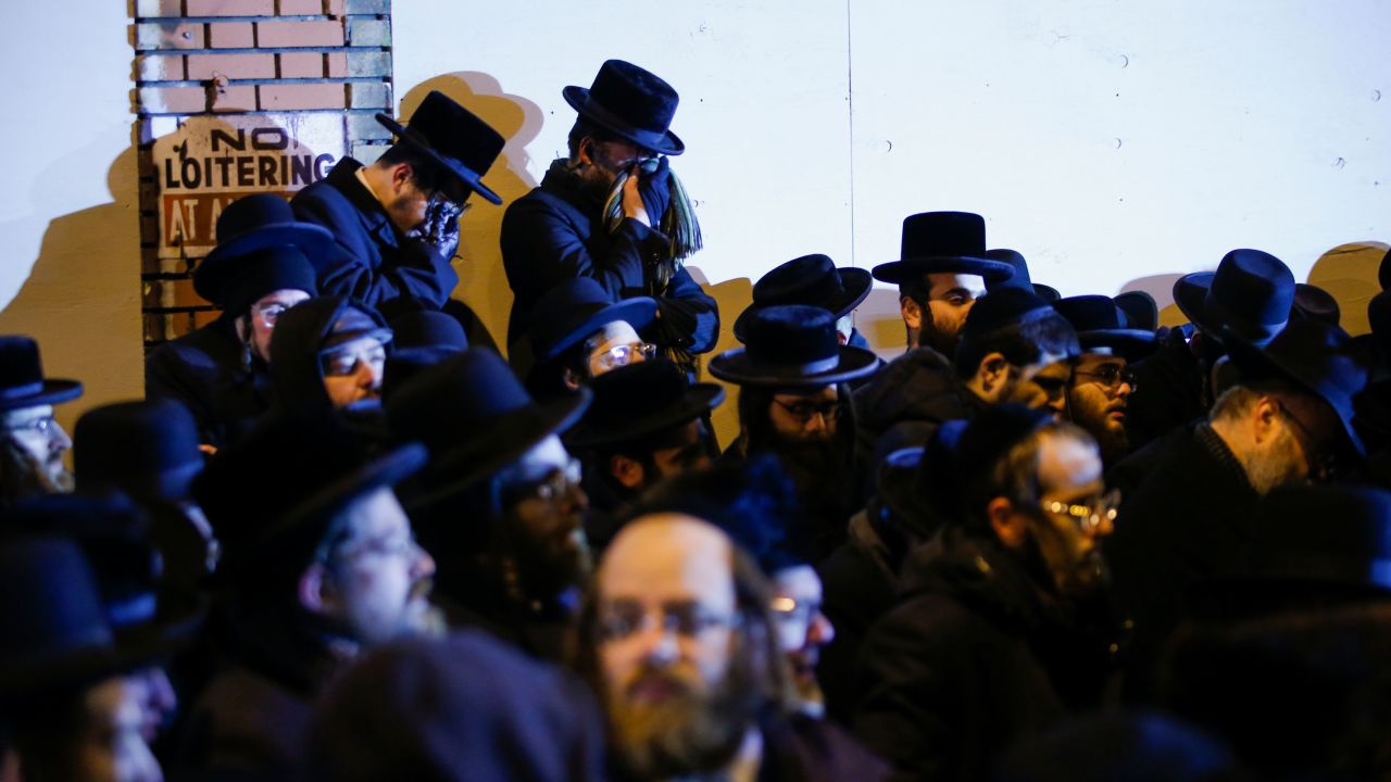 Orthodox Jewish men mourn during the funeral service of Mindy Ferencz who was killed in a kosher market that was the site of a gun battle in Jersey City, New Jersey.