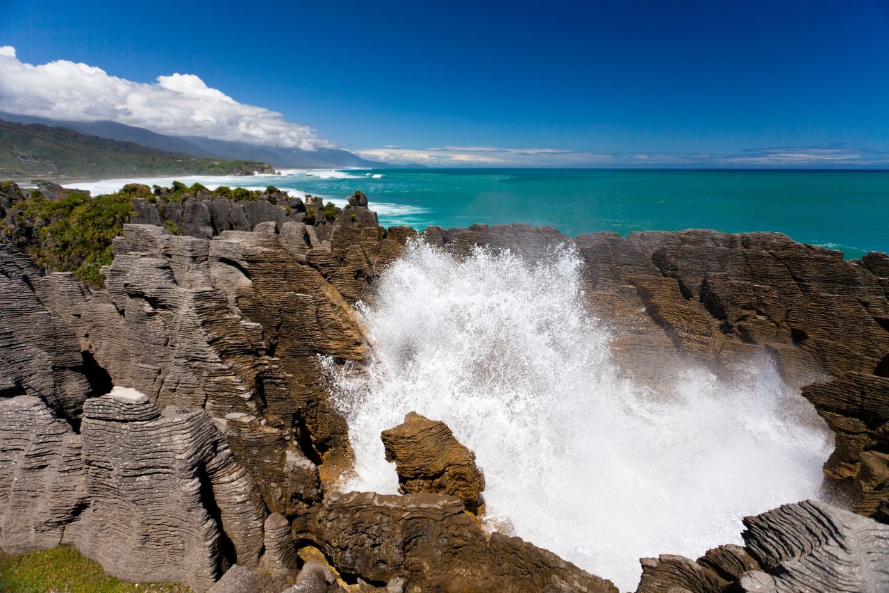 <strong>Punakaiki Pancake Rocks + Paparoa National Park: </strong>With the pounding waves of the Tasman Sea on one side and the tropical rainforest of the Paparoa National Park on the other, the drive between Greymouth and Westport is punctuated by the famous limestone formations and blowholes at Punakaiki.