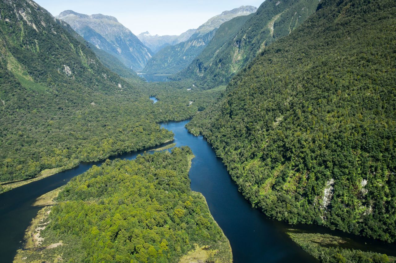 <strong>Milford Sound + Fiordland: </strong>The scenery here is on a super-sized scale - think towering cliffs, cascading waterfalls and seemingly bottomless waterways.