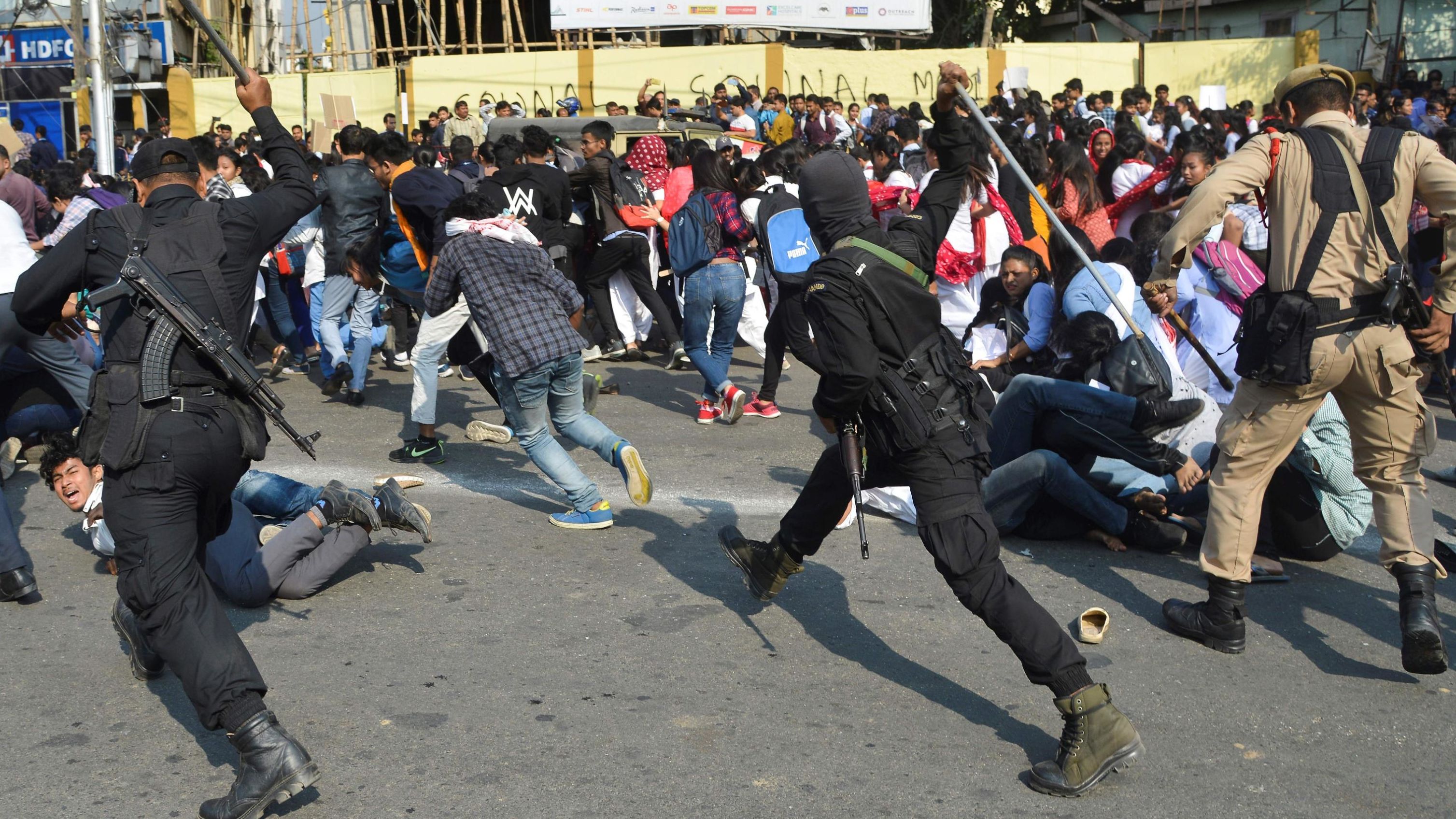 Security personnel use batons to disperse students protesting against CAB in Guwahati on December 11.
