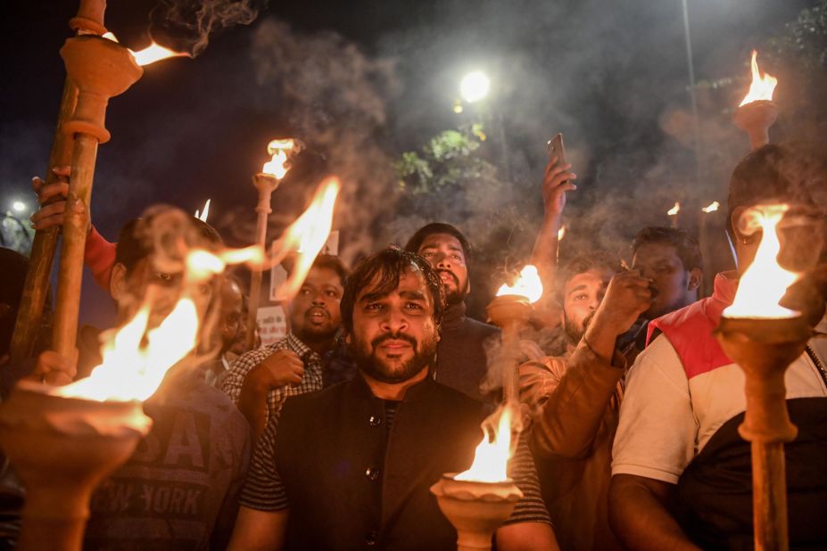 Indian youth congress members hold torches as they demonstrate in New Delhi on Wednesday, December 11.