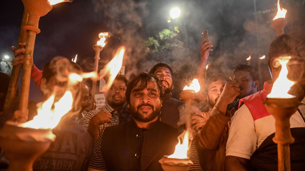 Demonstrators hold torches as they shout slogans against the government's Citizenship Amendment Bill (CAB), during a protest in New Delhi on December 11, 2019. 