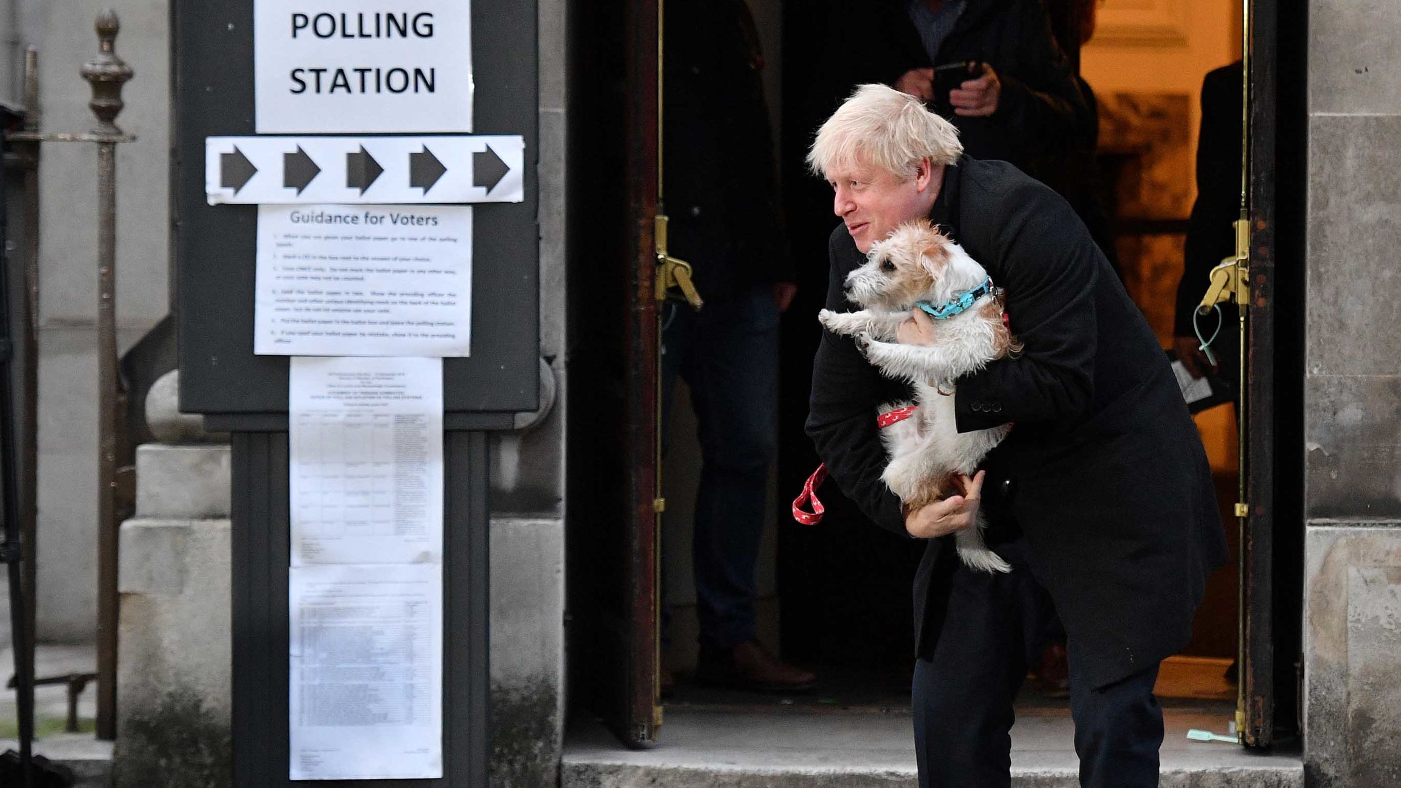 Johnson poses with his dog Dilyn as he leaves a polling station in London in December 2019.