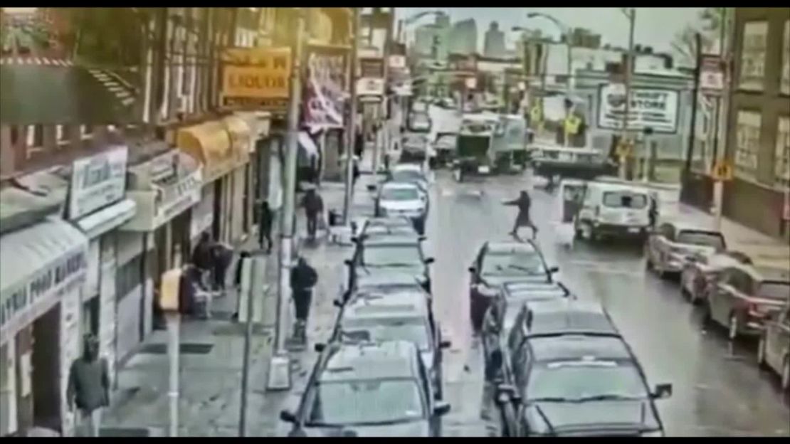 This still image from surveillance footage shows one of the shooters crossing the street toward the kosher market. The U-Haul van is seen on the right with doors open.