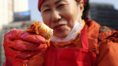 A woman makes kimchi, a traditional pungent vegetable dish, in Seoul, South Korea.