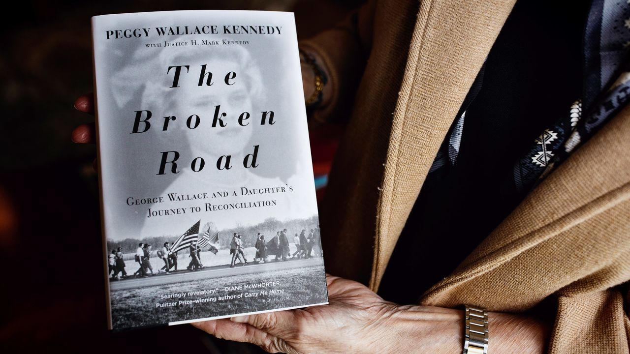Peggy Wallace Kennedy holds a copy of her book, "The Broken Road."