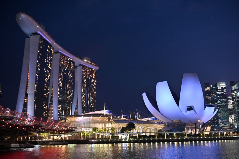 <strong>Marina Bay Sands:</strong> Designed by renowned architect Moshe Safdie, Marina Bay Sands' memorable trio of towers holds a roof garden and infinity pool. Illuminated in the foreground on the right is the ArtScience Museum. Shaped like a lotus flower, it is famous in its own right.