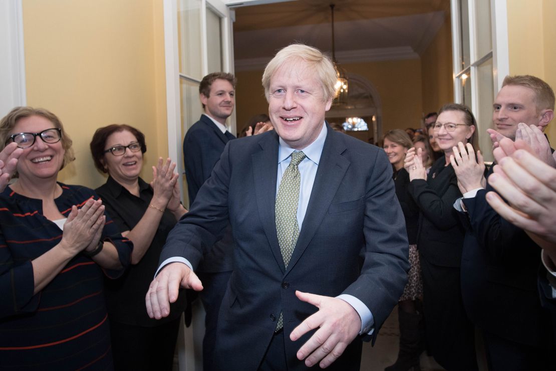 Boris Johnson is greeted by staff as he arrives back at 10 Downing Street after winning the 2019 general election.