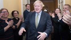 Britain's Prime Minister and Conservative Party leader Boris Johnson is greeted by staff as he arrives back at 10 Downing Street in central London on December 13, 2019, following an audience with Britain's Queen Elizabeth II at Buckingham Palace, where she invited him to become Prime Minister and form a new government. - Conservative Prime Minister Boris Johnson on Friday hailed a political "earthquake" in Britain after a thumping election victory which clears the way for the country to finally leave the EU next month after years of paralysing deadlock. (Photo by Stefan Rousseau / POOL / AFP) (Photo by STEFAN ROUSSEAU/POOL/AFP via Getty Images)