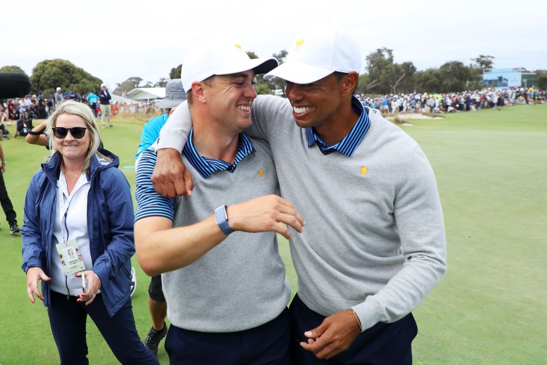 Tiger Woods (right) and Justin Thomas celebrate after winning their second match in Melbourne. 