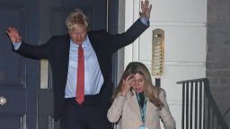 Britain's Prime Minister and Conservative Party leader Boris Johnson leaves Conservative Party headquarters with his partner Carrie Symonds and their dog Dilyn, in London, Friday, Dec. 13, 2019. Prime Minister Boris Johnson's Conservative Party appeared on course Friday to win a solid majority of seats in Britain's Parliament— a decisive outcome to a Brexit-dominated election that should allow Johnson to fulfill his plan to take the U.K. out of the European Union next month. (AP Photo/Thanassis Stavrakis)