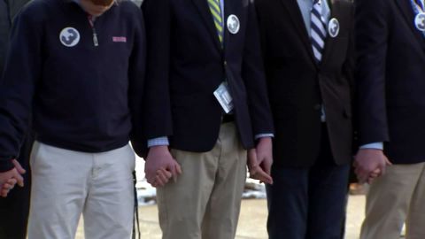 The students of St. John's Prep held hands as Frates' funeral procession passes by.
