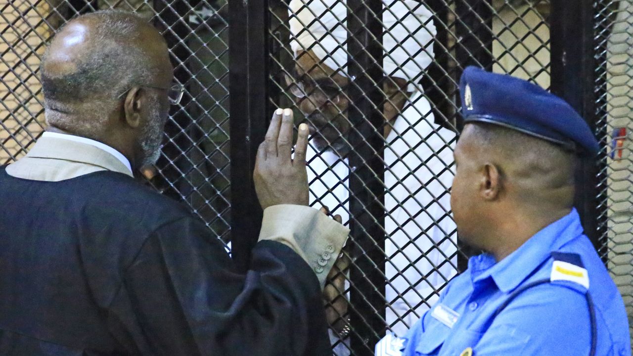 Ousted Sudan President, Omar al-Bashir, sits in a defendant's cage Saturday.