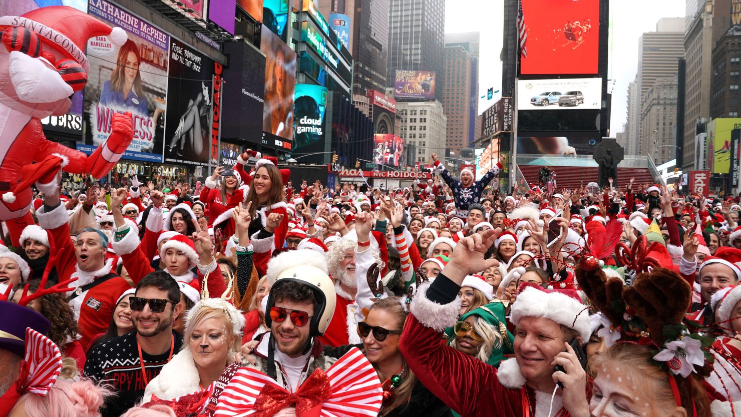 Revelers gather at the start of the SantaCon bar crawl at Father Duffy Square, a section of Times Square, on December 14, 2019.