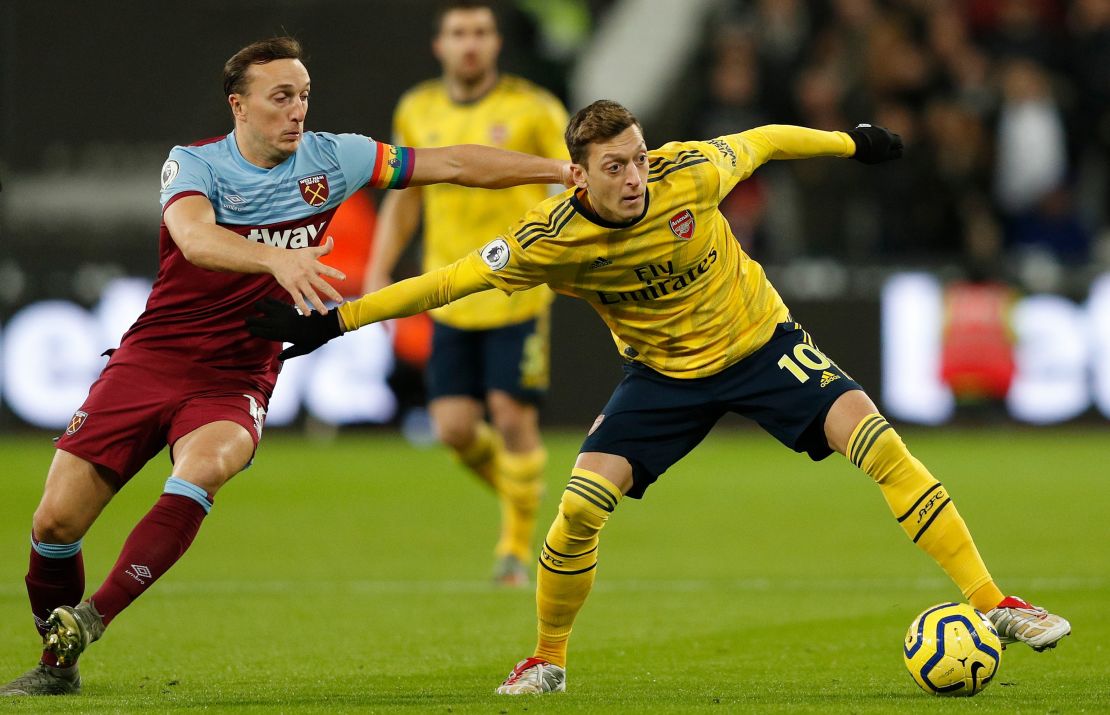 Mesut Ozil (L) in action for Arsenal against West Ham on December 9.