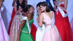 Miss Nigeria Nyekachi Douglas (L) and Miss Brazil Elis Coelho (R) support Miss Jamaica Toni-Ann Singh (C) as she is anounced Miss World 2019 during the the Miss World Final 2019 at the Excel arena in east London on December 14, 2019. (Photo by DANIEL LEAL-OLIVAS / AFP) (Photo by DANIEL LEAL-OLIVAS/AFP via Getty Images)