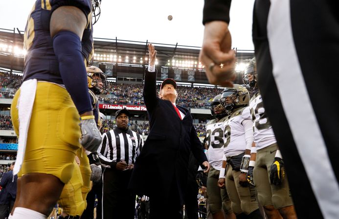President Donald Trump tosses a coin before the annual Army-Navy collegiate football game in Philadelphia, Pennsylvania, on Saturday, December 14. The three US Navy sailors who were killed in the Pensacola Naval Air Station shooting <a href="index.php?page=&url=https%3A%2F%2Fwww.cnn.com%2F2019%2F12%2F14%2Fus%2Farmy-navy-game-pensacola-shooting-honor-trnd%2Findex.html" target="_blank">were honored</a> at Saturday's game.
