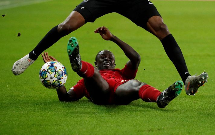 Liverpool's Sadio Mane fights for the ball against FC Red Bull Salzburg's Encok Mwepu during a match in Salzburg, Austria, on Tuesday, December 10.<br />