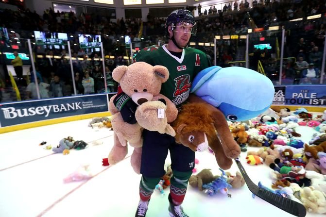 Thousands of Florida Everblades fans throw stuffed animals onto the hockey rink during the annual Florida Everblades "Teddy Bear Toss" on Saturday, December 14, in Estero, Florida. 