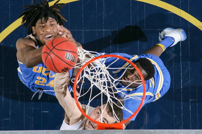 UCLA's Jalen Hill, Notre Dame's John Mooney and UCLA's Prince Ali fight for a rebound during a game at Purcell Pavilion in South Bend, Indiana, on Saturday, December 14. 