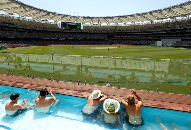 Cricket fans watch on from the pool in the Boundary Beach Club during the first day of the first test match between Australia and New Zealand on Thursday, December 12, in Perth, Australia.