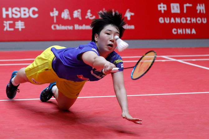 Akane Yamaguchi of Japan dives for a shot during the women's singles in the World Tour Finals in Guangzhou in south China's Guangdong province on Thursday, December 12. 