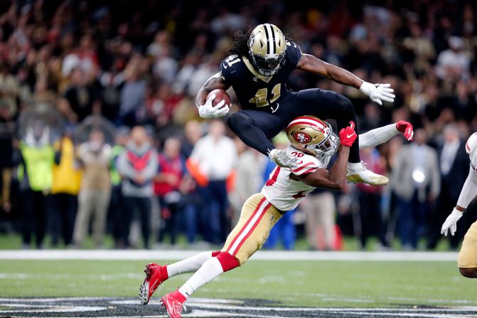 New Orleans Saints running back Alvin Kamara hurdles over San Francisco 49ers free safety Jimmie Ward during a game in New Orleans, Louisiana, on Sunday, December 8.