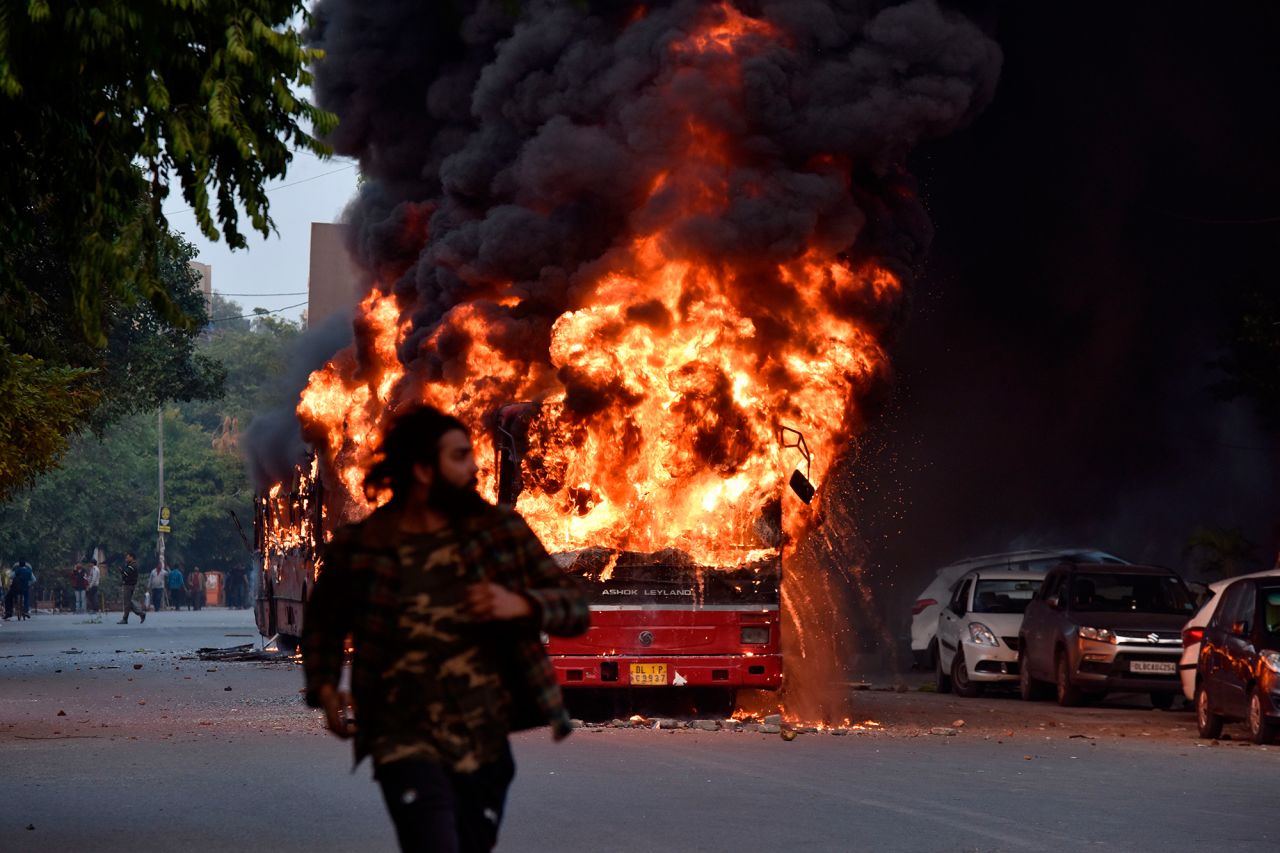A bus is seen on fire following a demonstration in New Delhi on Sunday, December 15.
