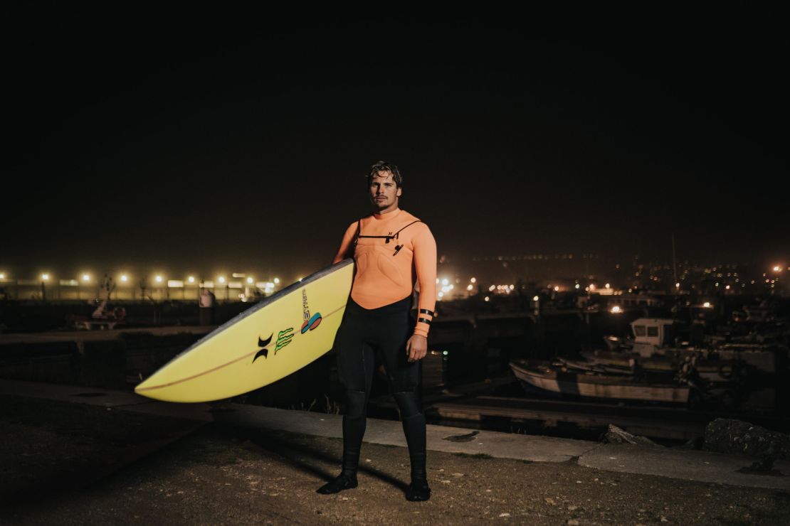 Nic von Rupp, with surfboard in hand, prepares to tackle the big waves of Nazaré in the early hours.