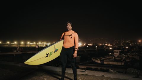 Nic von Rupp, with surfboard in hand, prepares to tackle the big waves of Nazaré in the early hours.